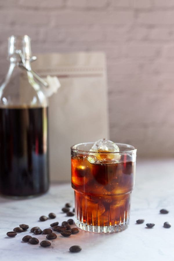 glasses of homemade cold brew coffee with cied on white table background.